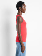 Solid red ribbed knit scoop tank top, fitted and modeled in profile.