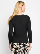 Black bubble knit long-sleeve top with ruffled cuffs.