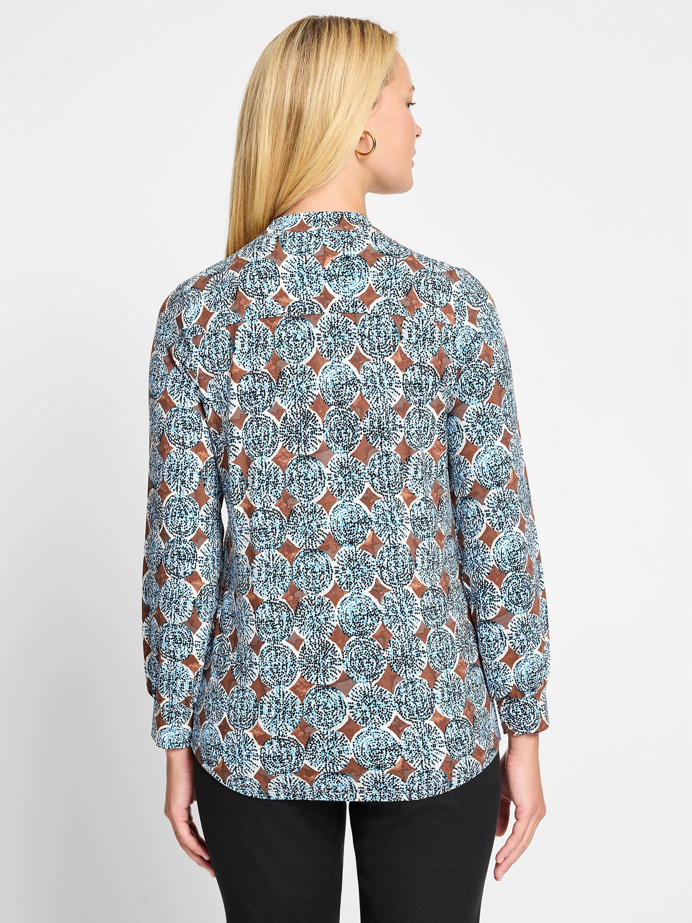 Long-sleeve top with an aqua, brown, and white sand dollar pattern.