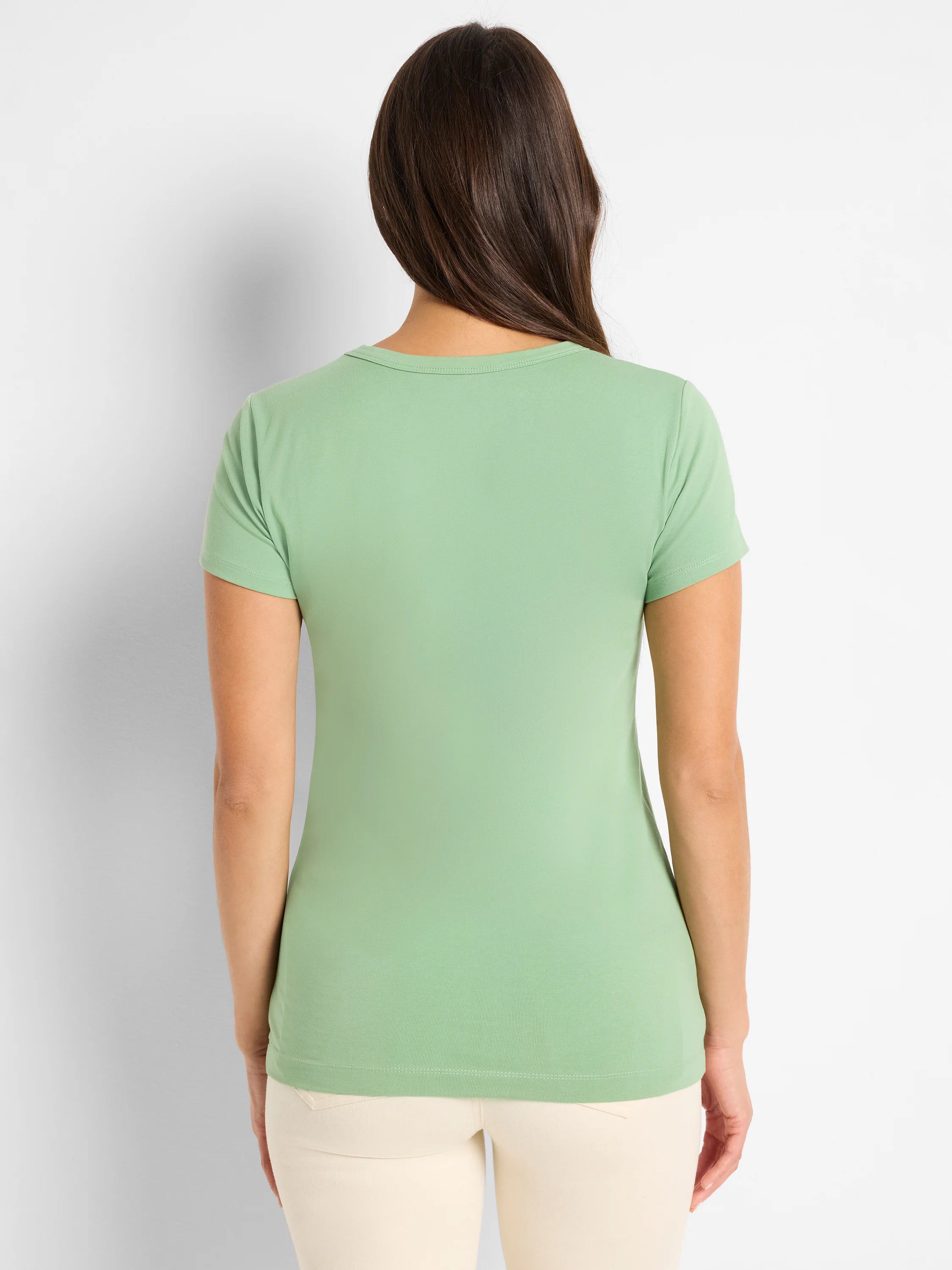 Light green crew neck T-shirt, back view on model. Short sleeves, fine knit texture.