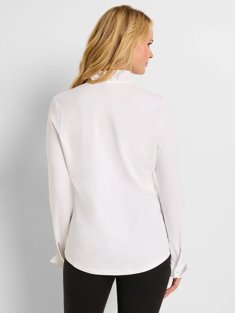 White long-sleeve shirt with a high ruffled collar, buttoned cuffs, and curved hem. Model shown from behind.