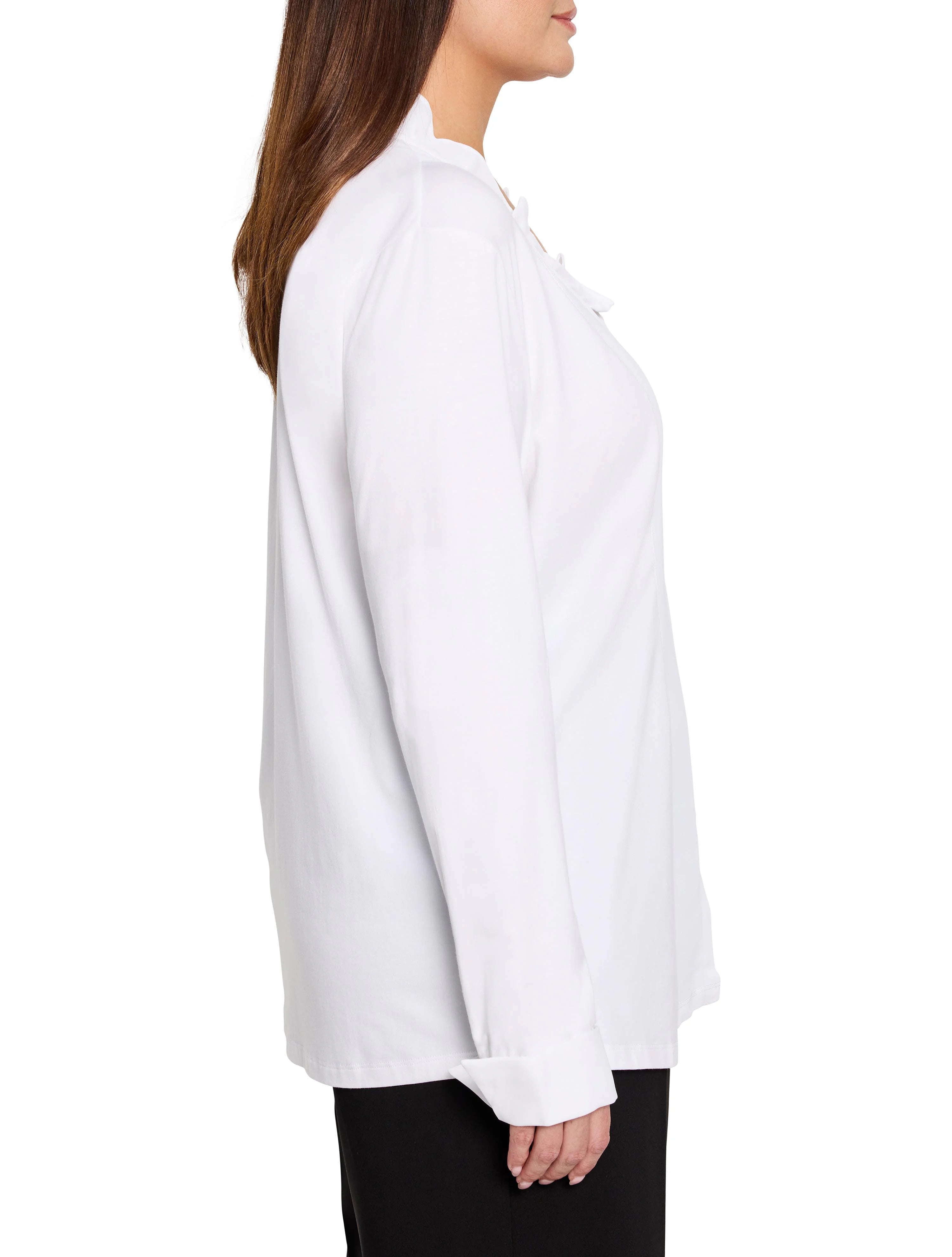 White long-sleeve shirt with ruffled collar, vertical ruffles down front, and wide cuffed sleeves.