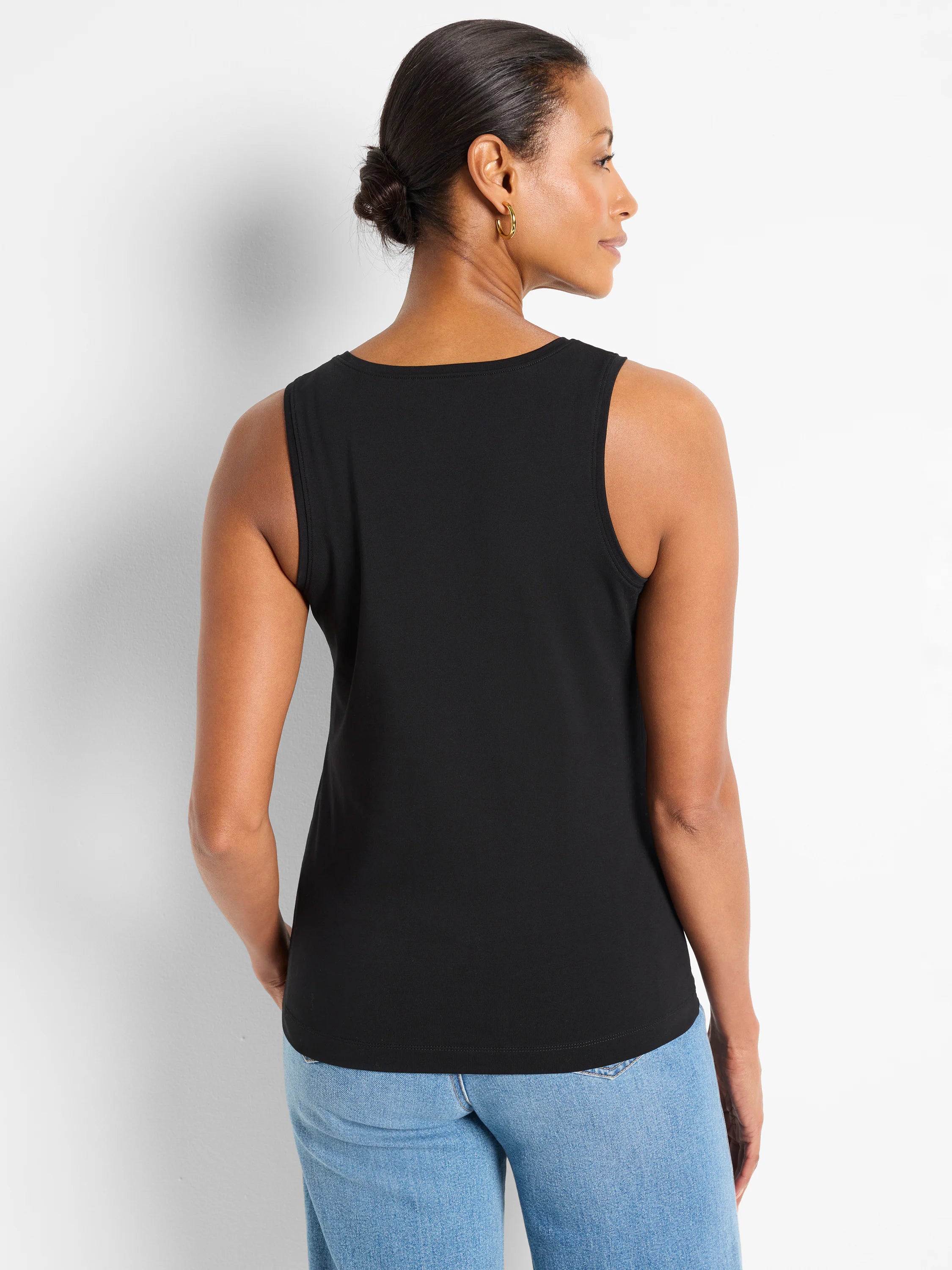 Black knit tank top, sleeveless with a round neck. Model viewed from the back.