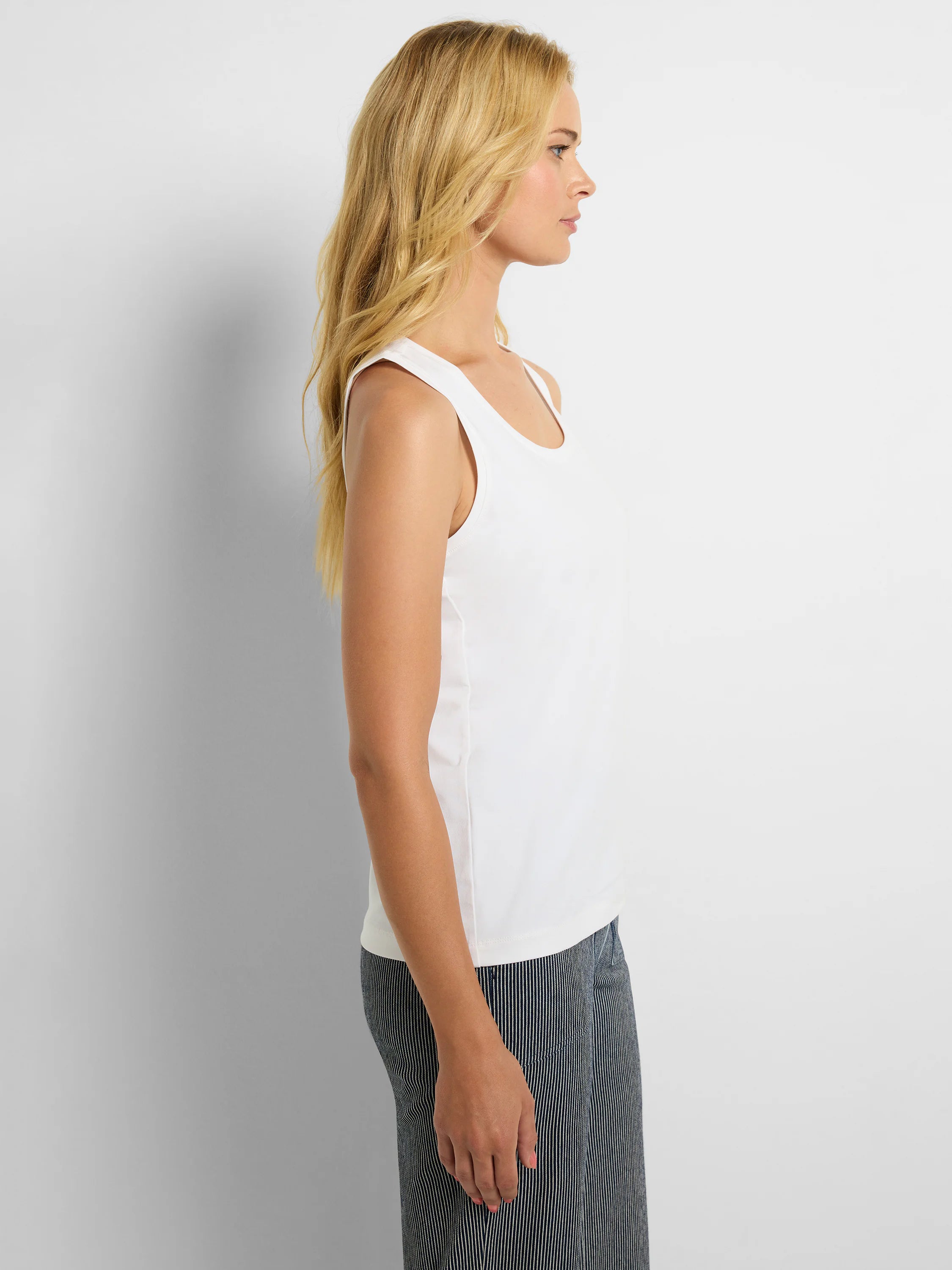 White knit tank top with a scoop neckline and wide shoulder straps.