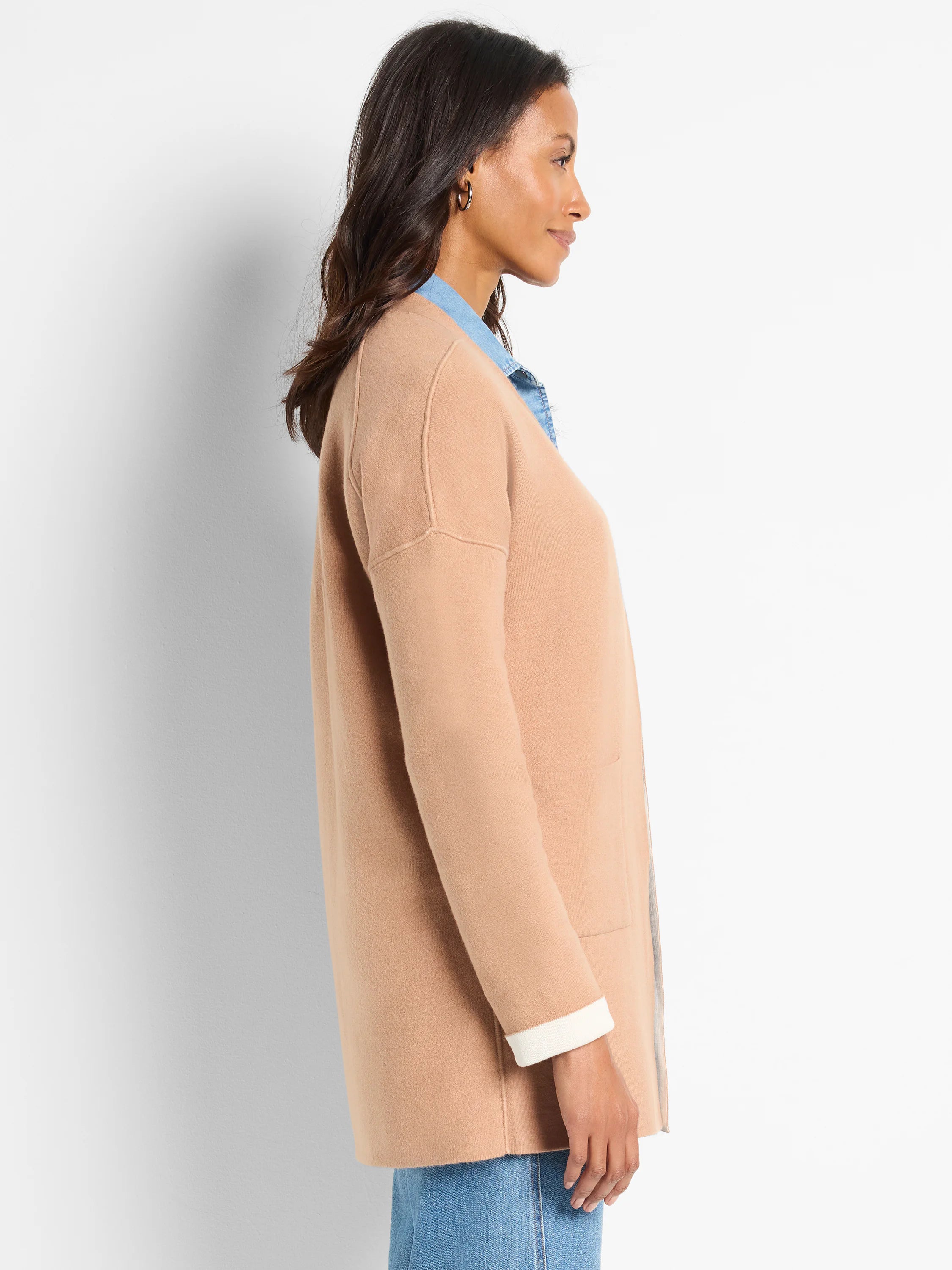 Tan knit jacket with open front & long sleeves. Reversible; shows white cuff lining & hint of light gray on reverse side.