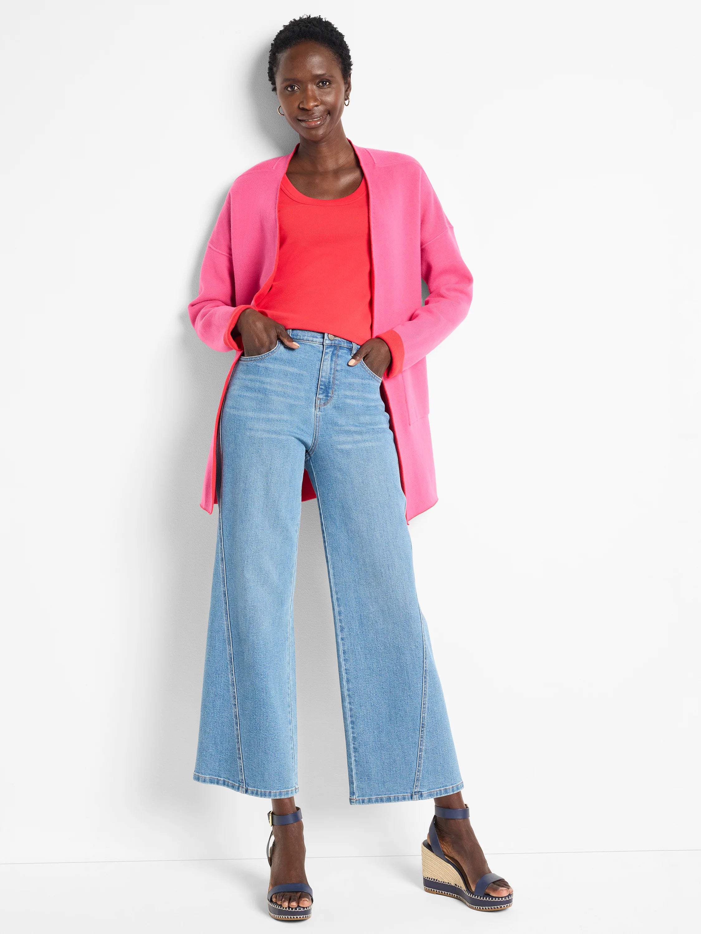 Reversible knit jacket in pink and coral. Open front, long sleeves.
