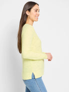 Pale lime green long-sleeve sweater featuring a subtle knit texture and small side slits at the hem.