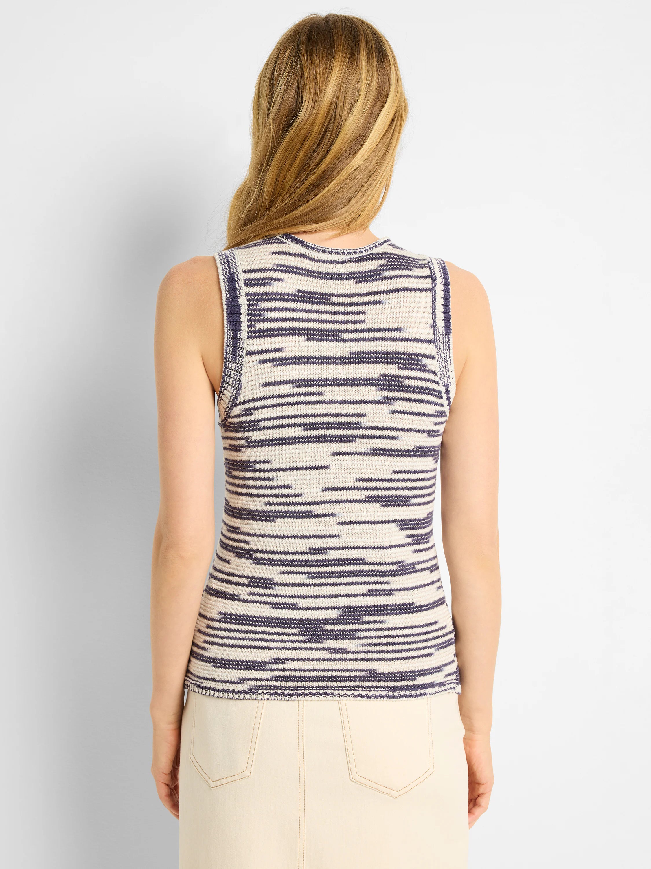 Sleeveless knit tank in cream and indigo with horizontal wavy patterns. Back view.