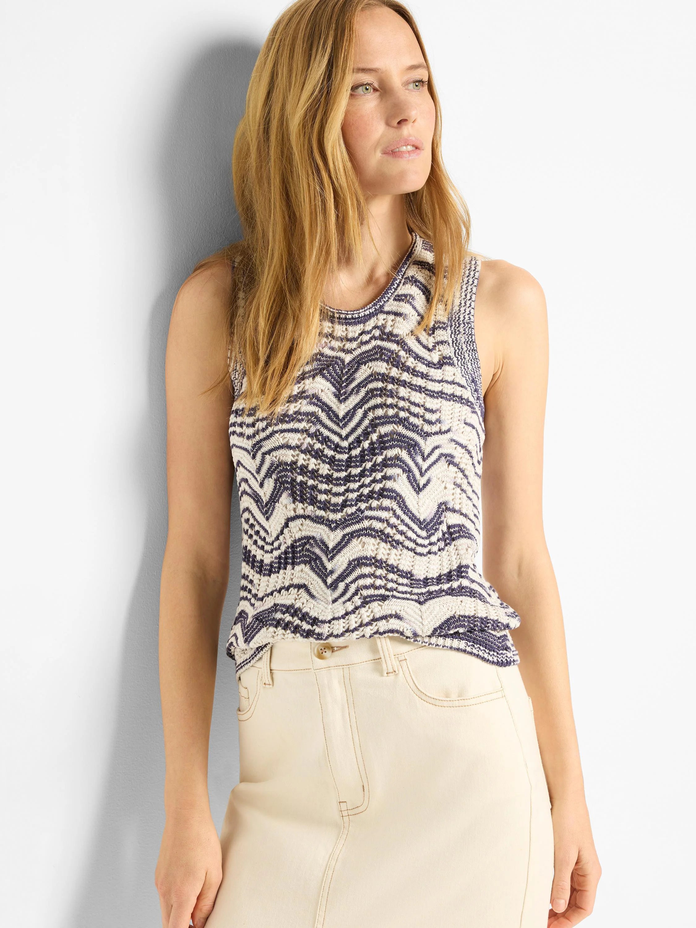 Cream and navy knit tank top with a wavy pattern and crew neck. Sleeveless design.
