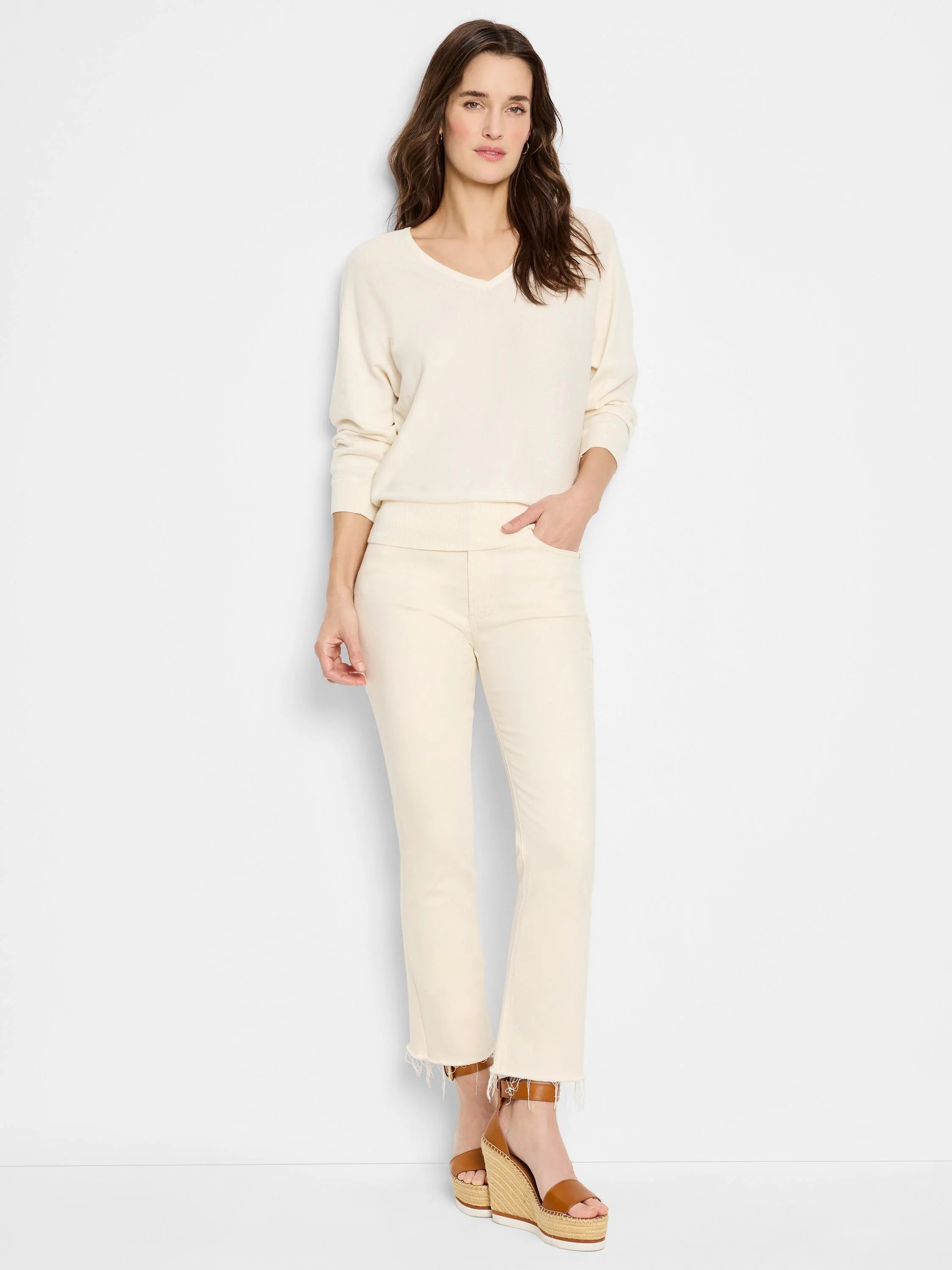 Relaxed cream V-neck sweater with long sleeves, ribbed cuffs, and hem.