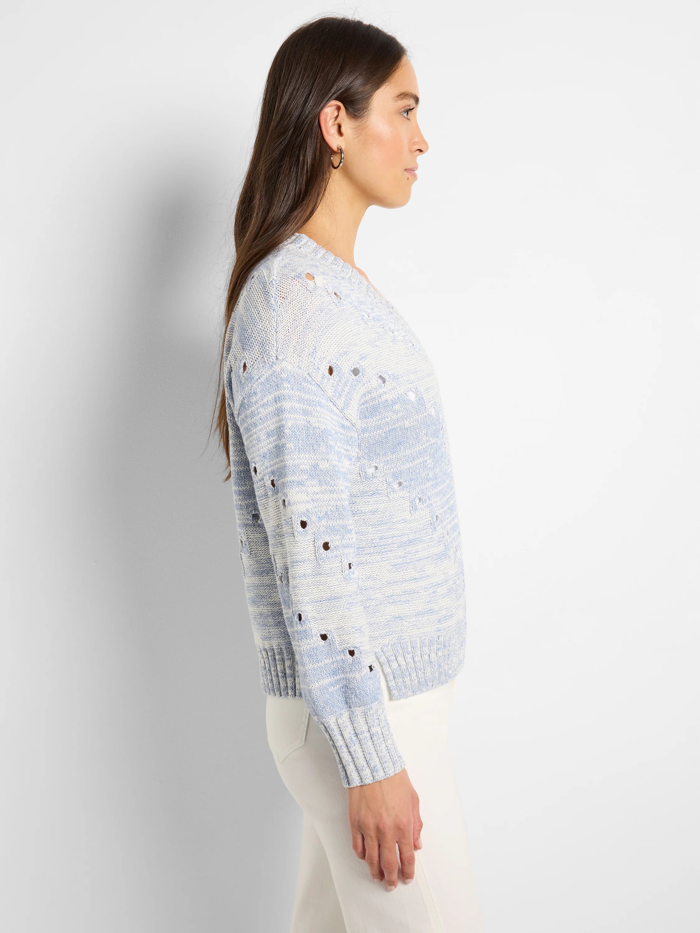 Light blue and white marled sweater with pointelle holes and ribbed cuffs.