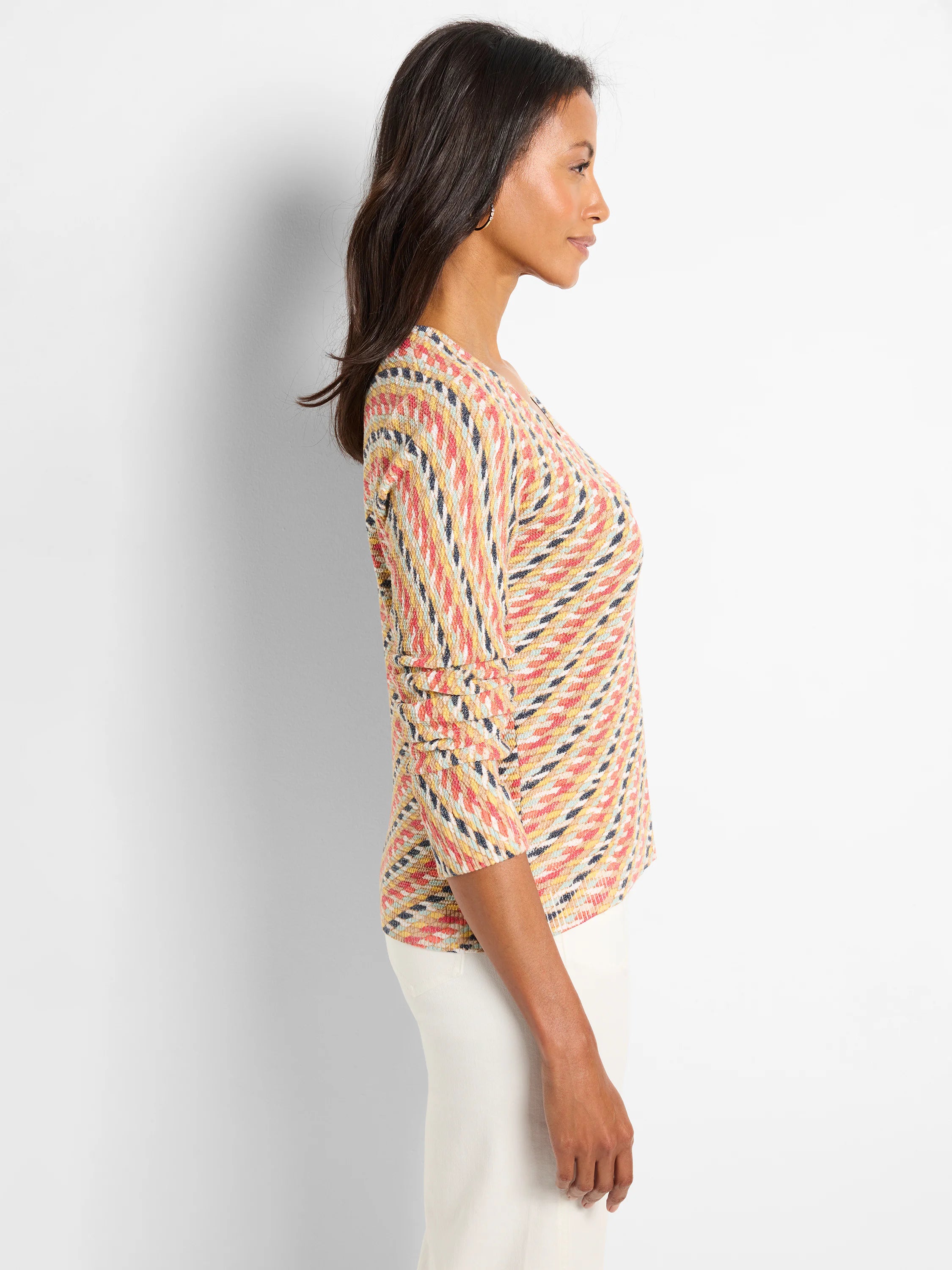 Textured knit sweater: multi-color pattern in coral, yellow, teal, black, cream. 3/4 sleeves, V-neck.