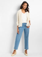 Cream open-front knitted cardigan with long fringe trim along the front edges.