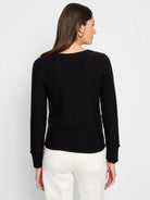 Black crew neck sweater with long sleeves, subtle garter knit texture, ribbed cuffs and collar.