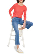 Coral garter knit crew neck sweater with long sleeves and ribbed cuffs.