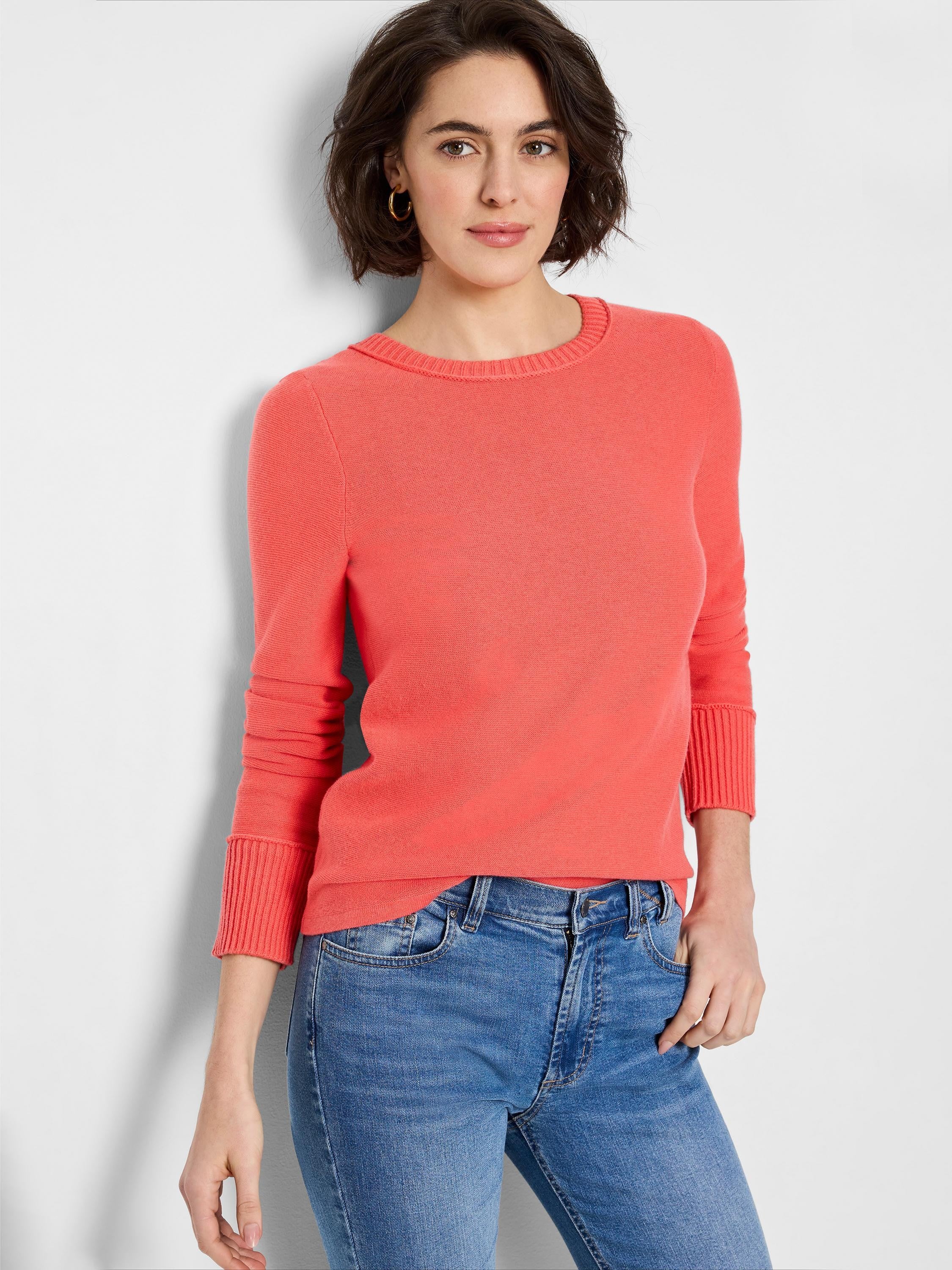Coral garter knit crew neck sweater with long sleeves, ribbed collar, cuffs, and hem.