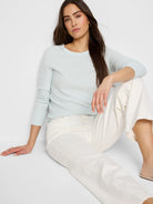 Pale blue crewneck sweater with ribbed cuffs. Long sleeves.