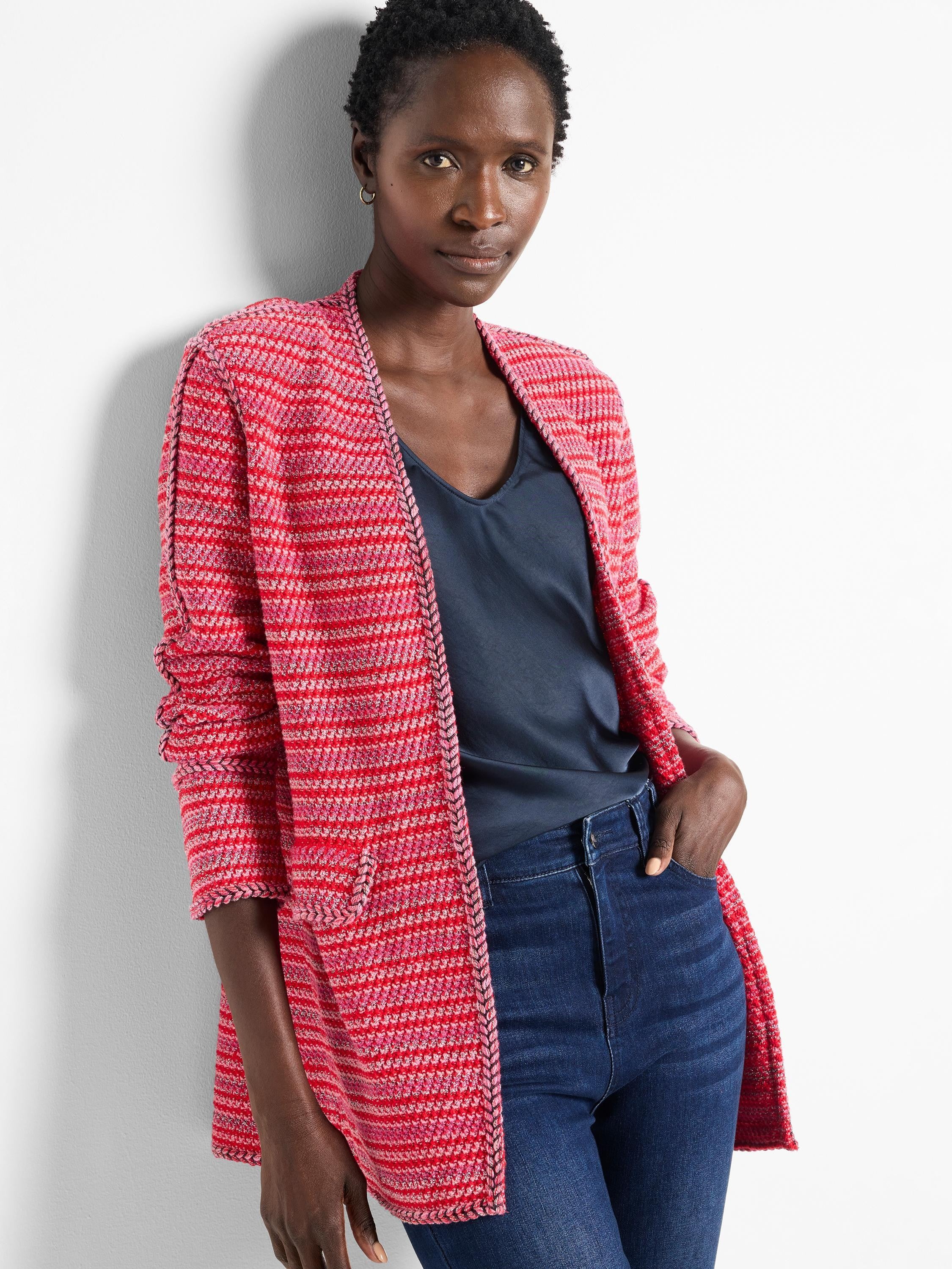 Red and pink striped cardigan with dark trim. Open front, long sleeves.
