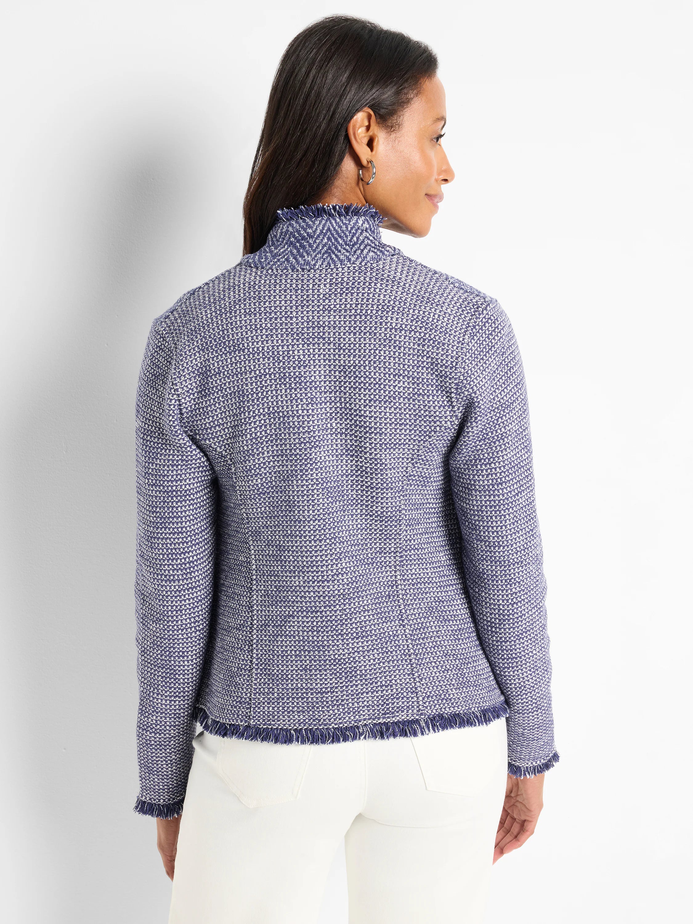 Blue and white textured knit jacket with a high notched collar and frayed edges. Rear view.