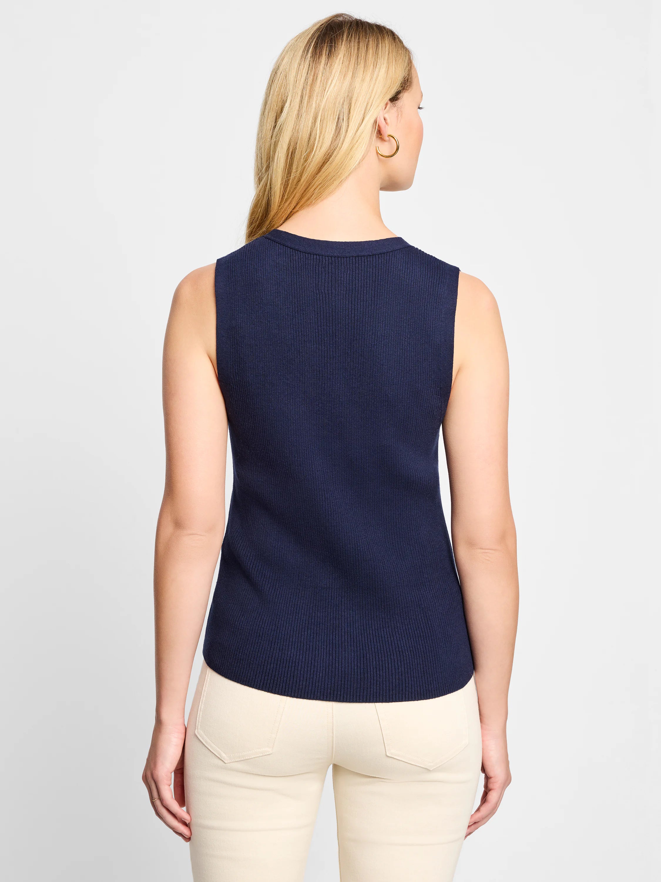 Here's alt text following accessibility best practices:
"Navy blue, ribbed sleeveless sweater vest.  Back view.