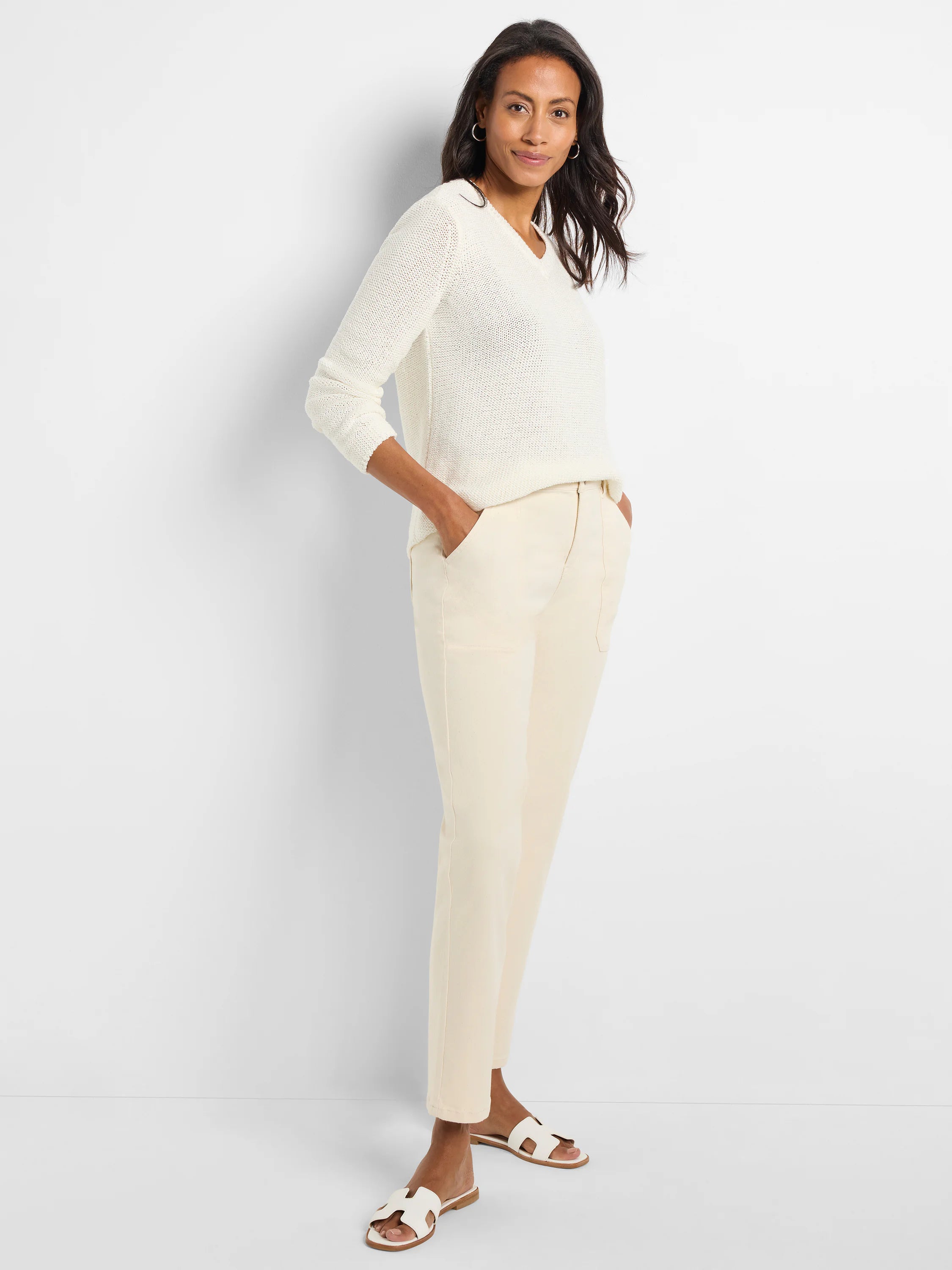 Off-white, textured knit v-neck sweater; long sleeves.