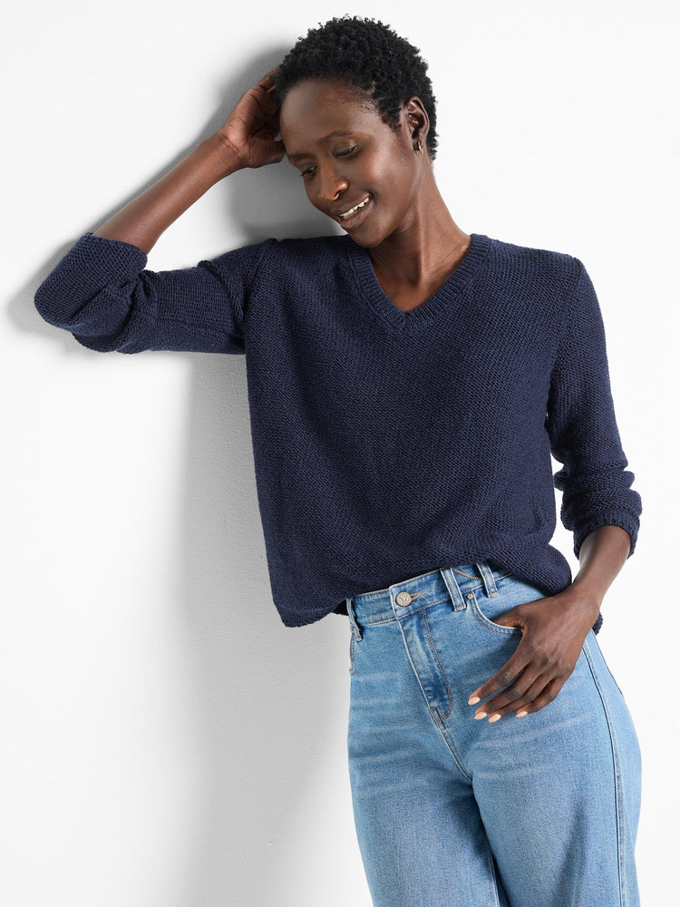 Navy blue, textured v-neck sweater. Long sleeves.