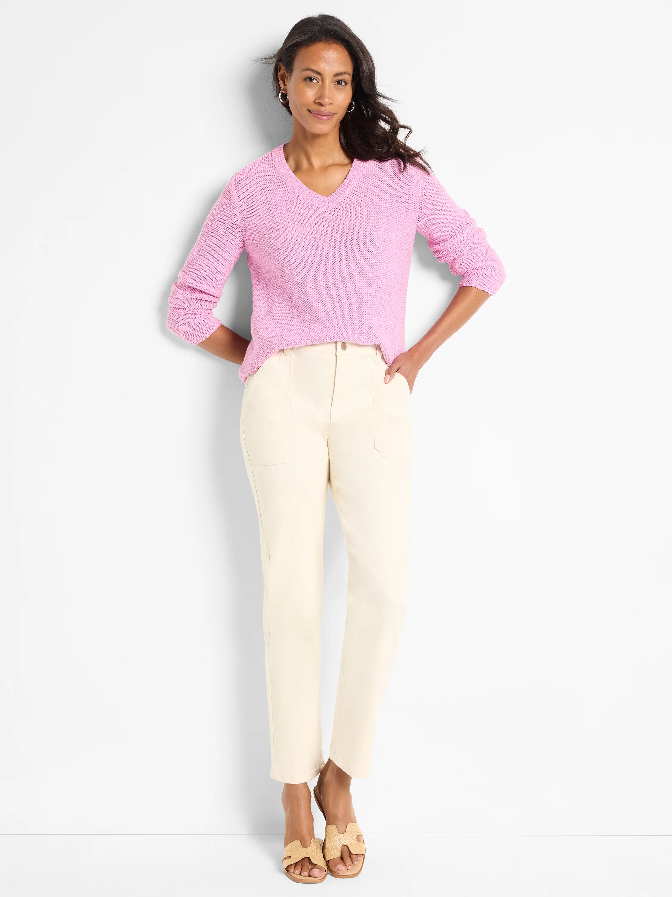 Light pink, V-neck, long-sleeved knit sweater. Textured fabric.