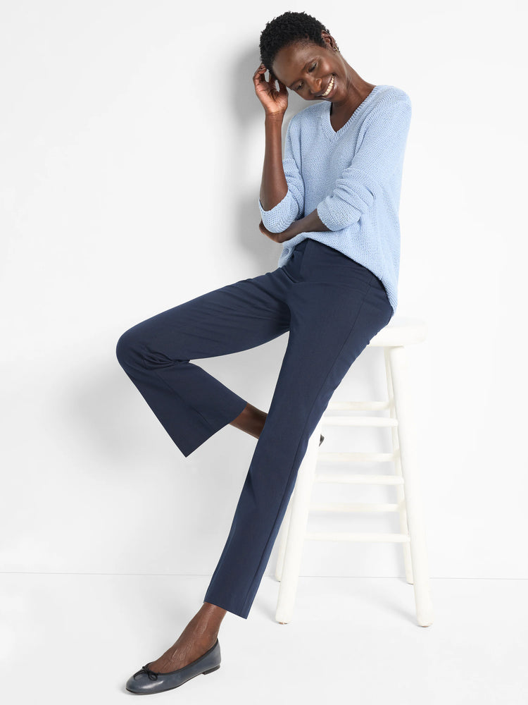 Light blue v-neck sweater, textured knit. Shown with dark navy pants.