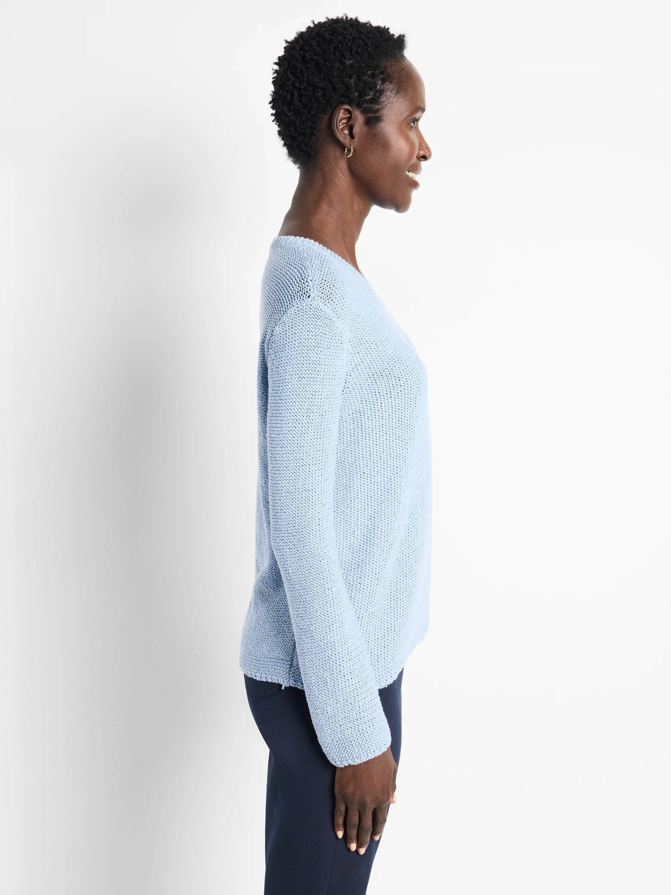 Light blue, loosely knit, long-sleeved sweater; V-neck.