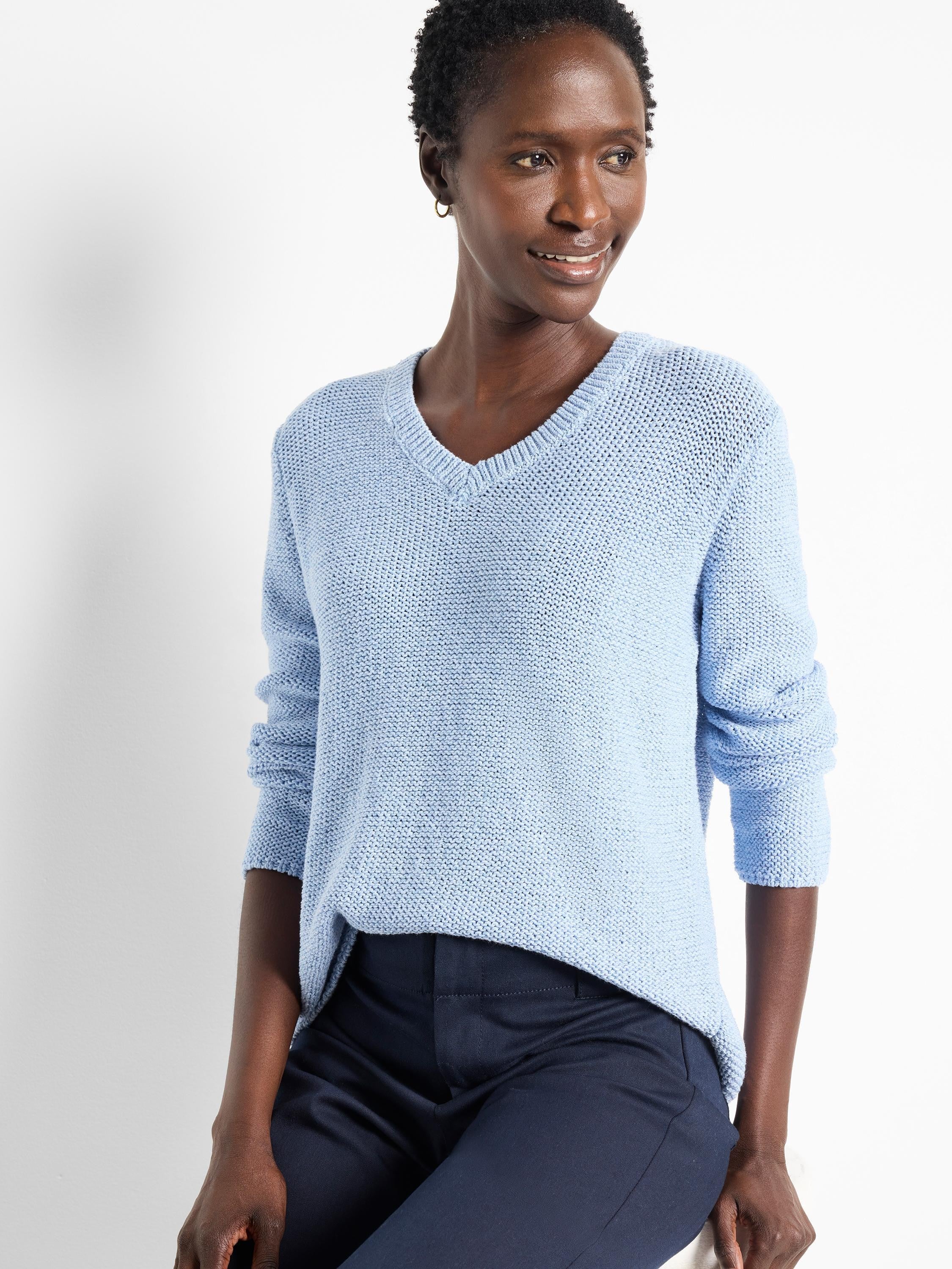 Light blue, V-neck, textured knit sweater. Long sleeves.
