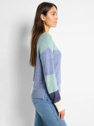 Horizontal stripes: light blue, mint green, navy, off-white cuffs. Knit sweater.