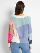 Color-blocked knit sweater.  Cream, pale pink, light blue, lavender, and brown sections.  Long sleeves, ribbed cuffs and hem.