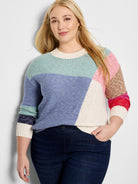 Color-blocked crewneck sweater.  Features teal, periwinkle, cream, tan, and pink sections.  Long sleeves with cream,...