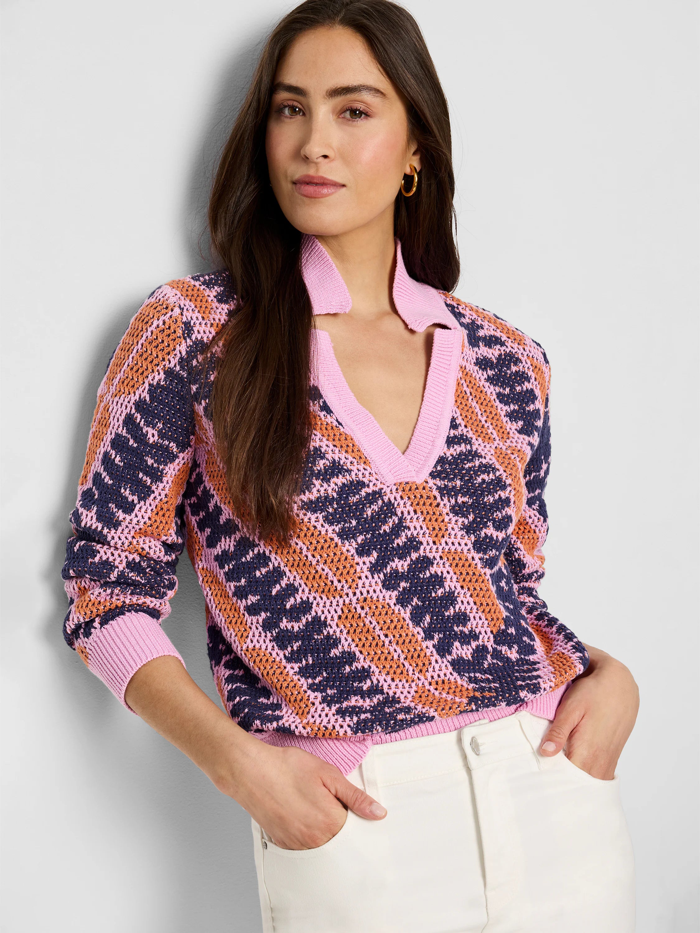 Pink, orange, and navy blue jacquard knit sweater. V-neck, squiggle pattern. Long sleeves.