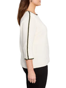 Off-white ribbed sweater with black and gold trim along the sleeves and neckline.  Three-quarter sleeves.