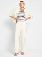 Cream sweater with horizontal stripes in black, brown, and cream.