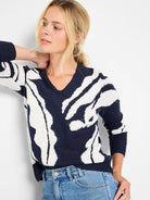 Navy blue sweater with an off-white abstract pattern.  V-neck, three-quarter sleeves.