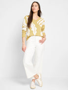 Mustard yellow sweater with white leaf pattern, long sleeves, and V-neck.