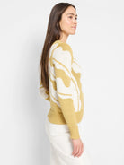 Mustard yellow and off-white knit sweater. Abstract pattern. Long sleeves, ribbed cuffs and hem.