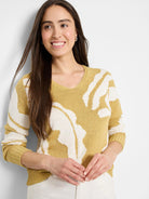 Mustard yellow knit sweater with off-white abstract pattern.  V-neck. Long sleeves.