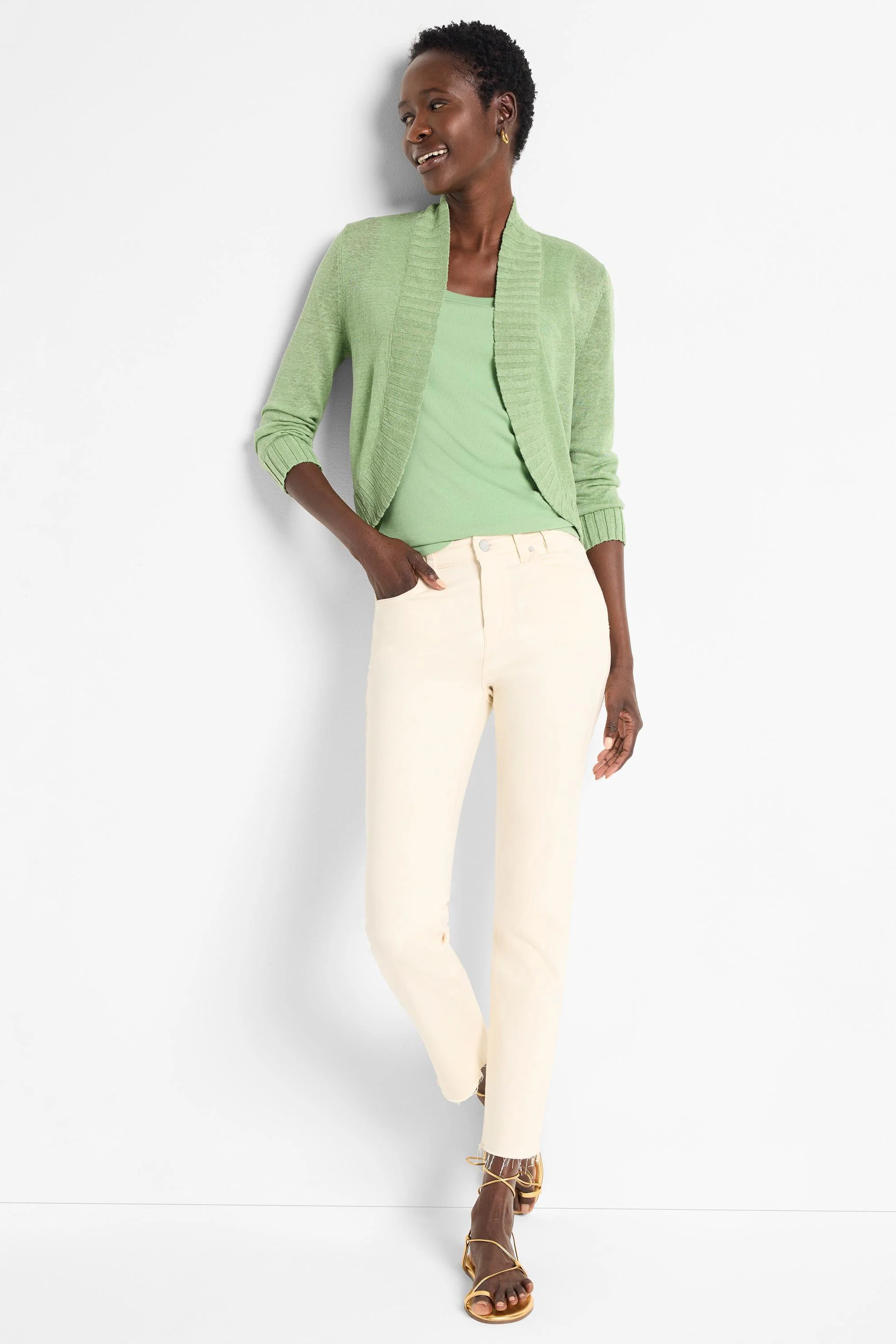 Light green bolero cardigan with a textured shawl collar, open front, and 3/4 length sleeves.