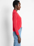 Red bolero cardigan with long sleeves, ribbed cuffs, and an open front.