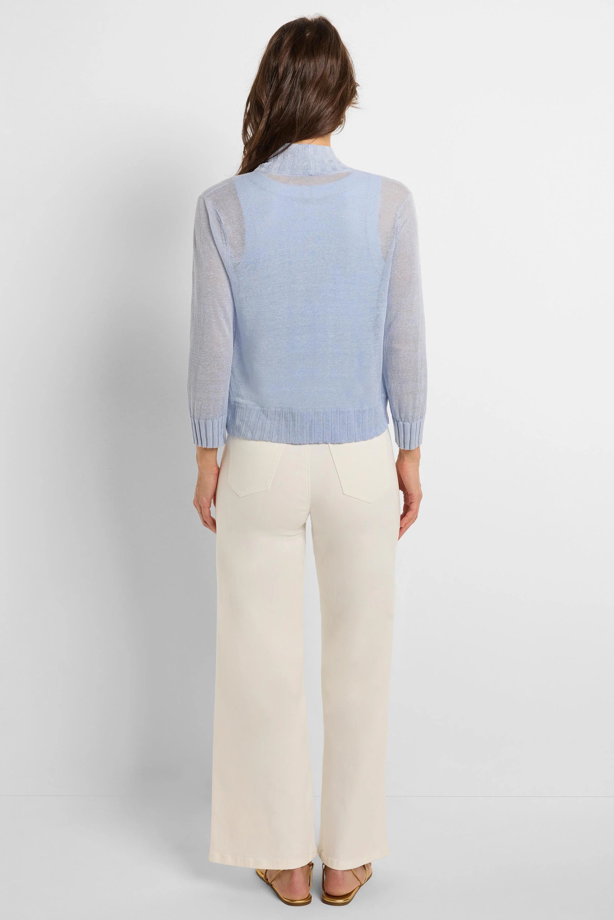 Light blue sheer knit bolero cardigan, long sleeves, cropped, ribbed cuffs & hem, back view.