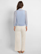 Light blue sheer knit bolero cardigan, long sleeves, cropped, ribbed cuffs & hem, back view.