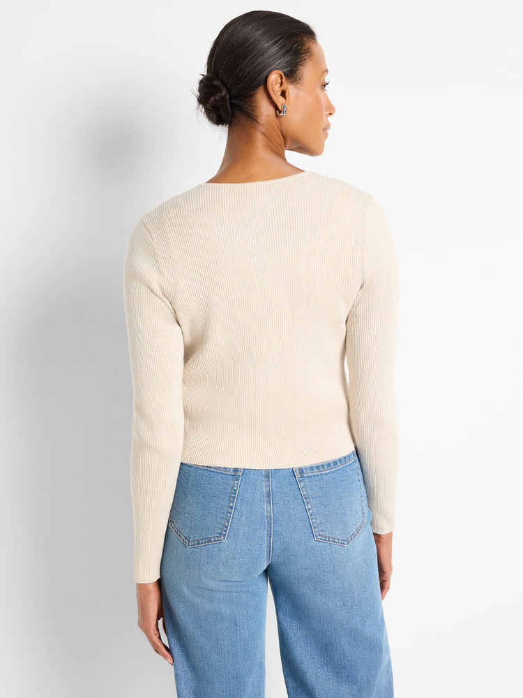 Cream ribbed knit long-sleeve cardigan on a model, viewed from behind.