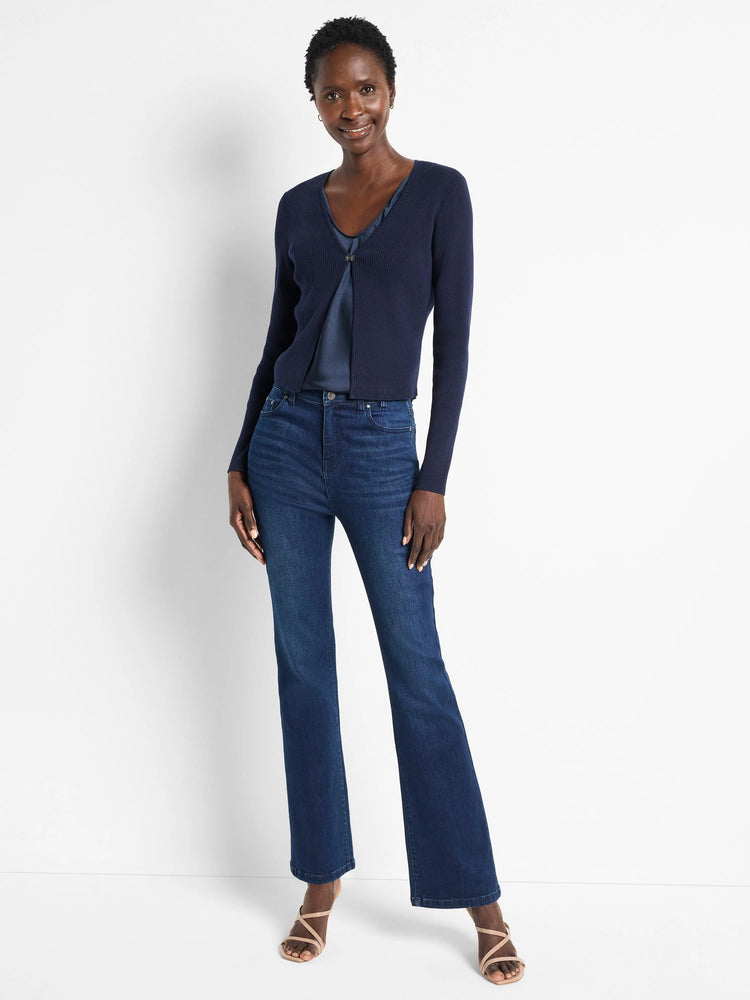 Dark navy ribbed cardigan with long sleeves, a short length, and a decorative front clasp.