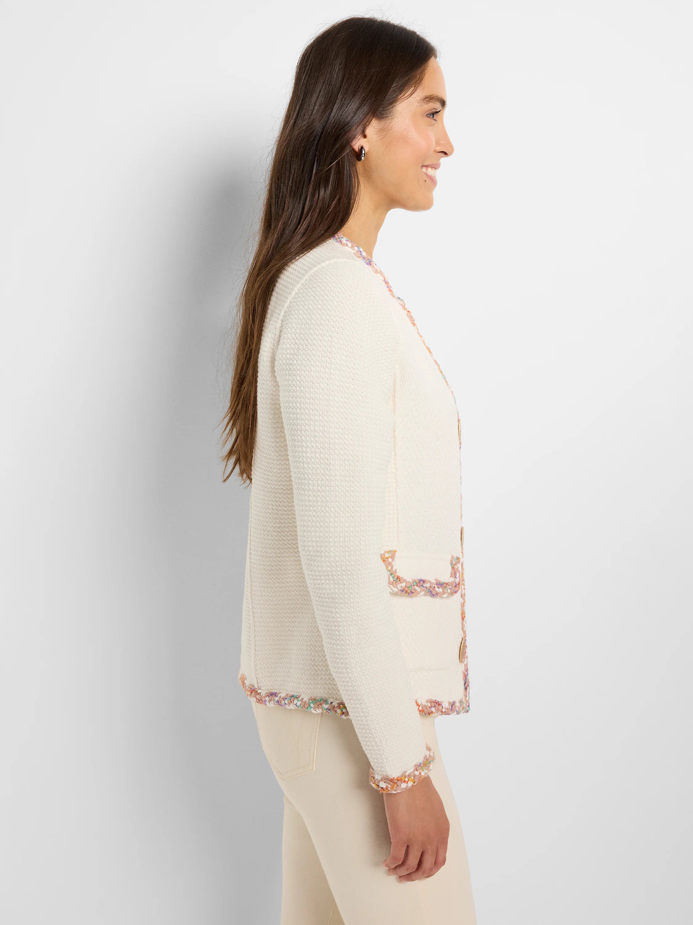 Off-white knit jacket with multicolored trim; features pockets and buttons.