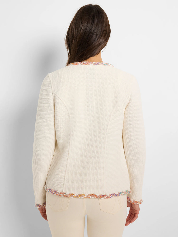 Cream-colored knit jacket with multicolor trim at neckline and cuffs. Textured fabric.