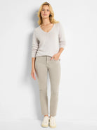Light beige V-neck sweater with a textured cord knit and long sleeves.