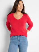 Red, long-sleeve V-neck sweater with a visible ribbed knit texture.
